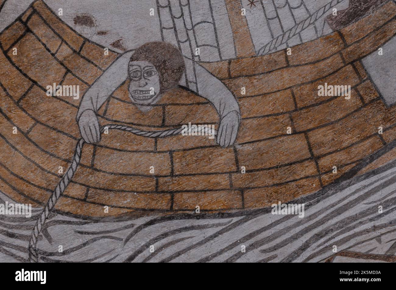 seasick sailor haning out over the gunwale, an old fresco from the 1500s in Kirke Hyllinge church, Denmark, October 4, 2022 Stock Photo