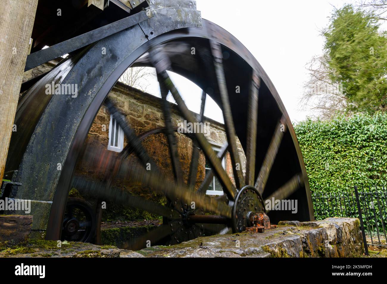 Spinning water wheel at an Irish mill Stock Photo