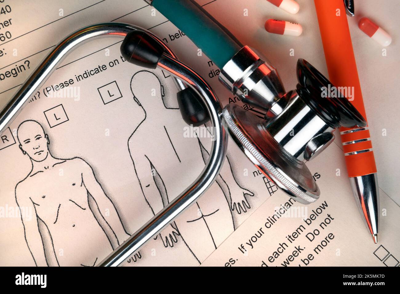 Medicine - Stethoscope and clinicians notes on a doctors desk. Stock Photo