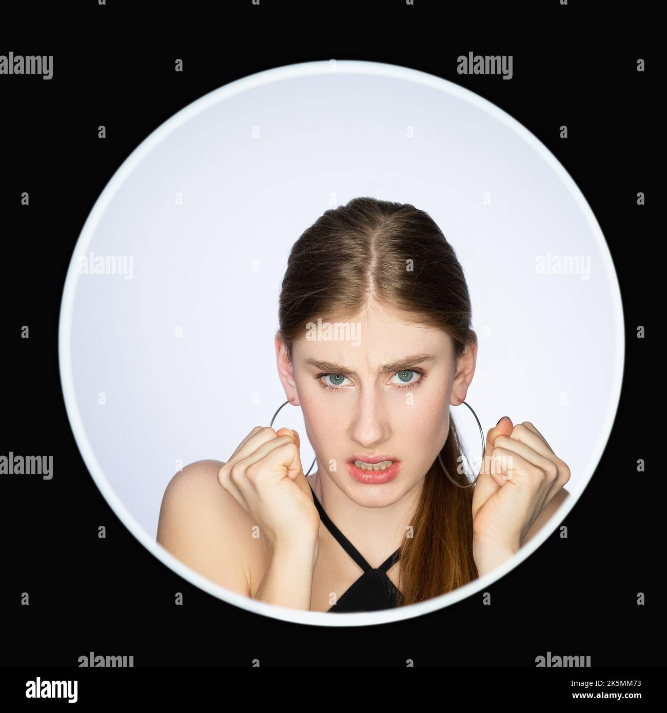 Angry woman. Hate feeling. Anxiety frustration. Headshot portrait of furious annoyed mad girl face isolated on neutral background in circle avatar fra Stock Photo