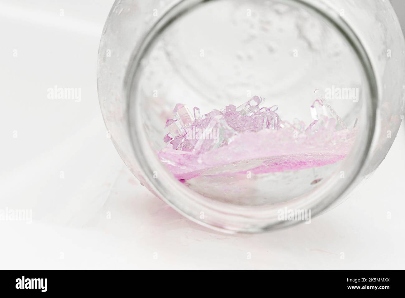 Chemical experiment on growing crystals. Crystal grown in a jar. Stock Photo