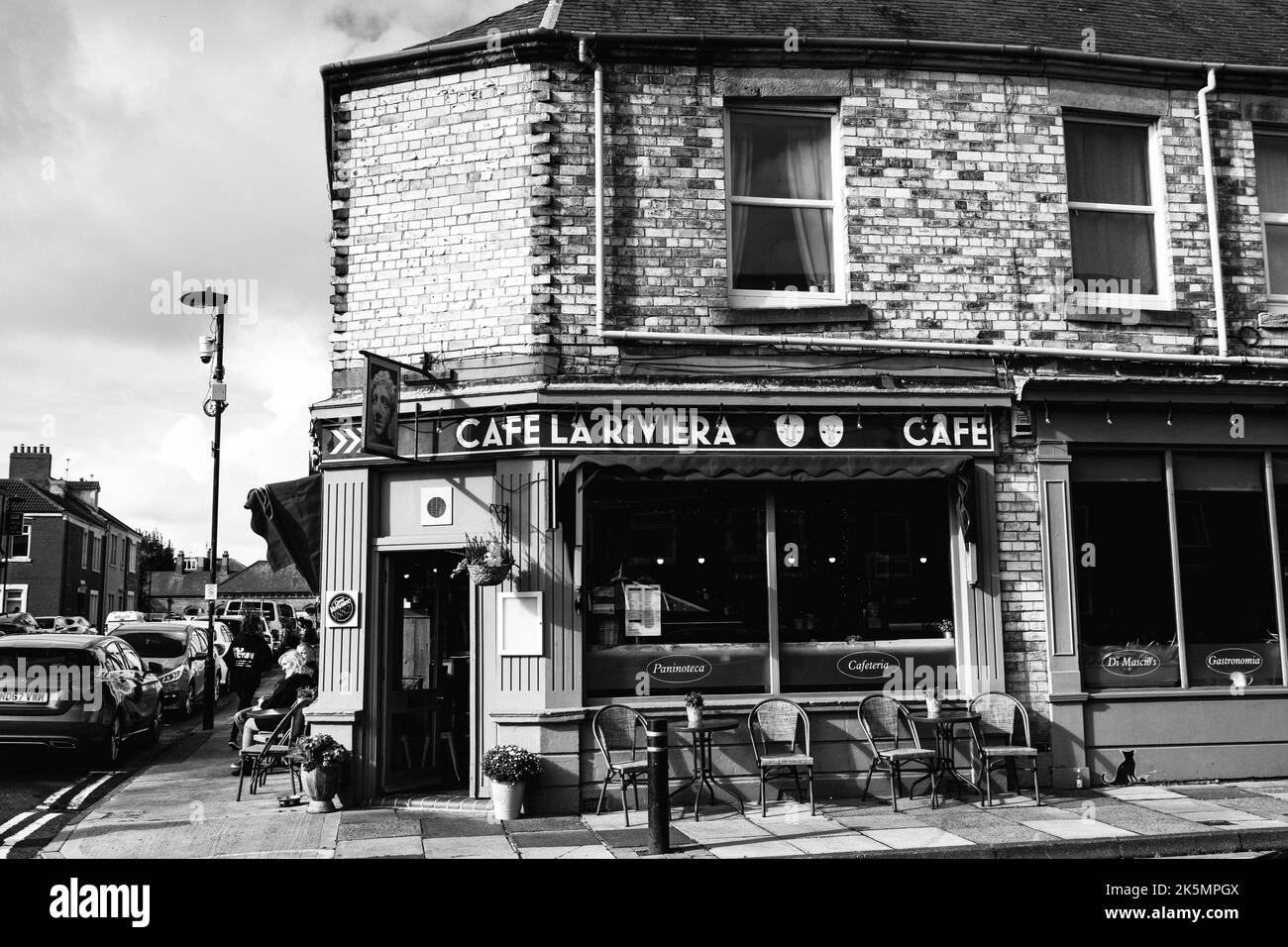 A black and white image of the front of Cafe La Riviera in Cullercoats