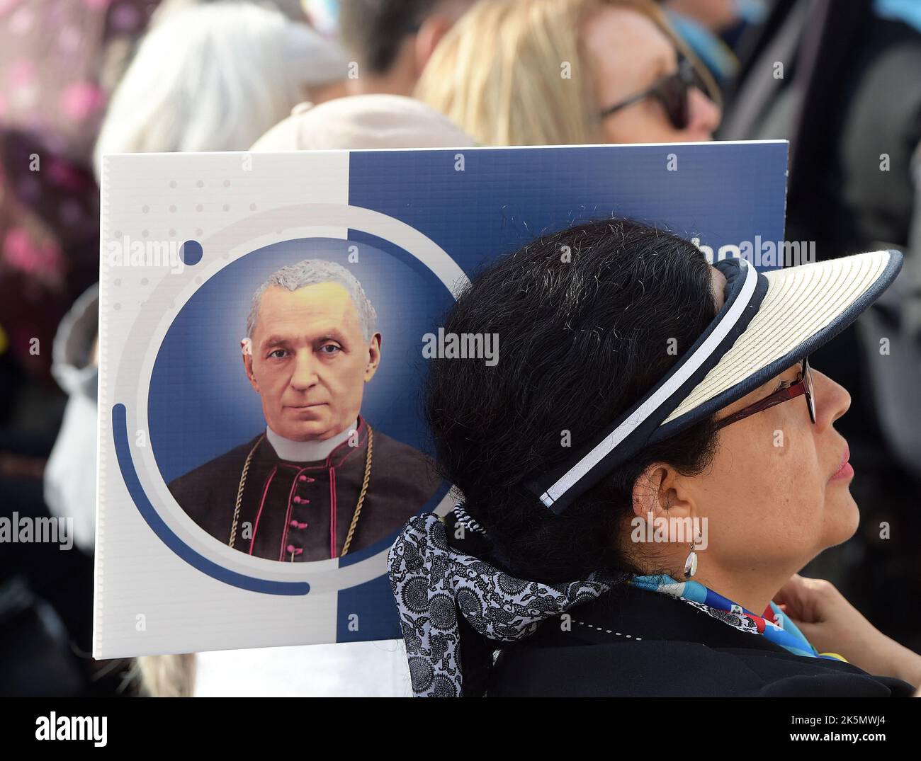 A pilgrim with a portrait of new Saint Giovanni Battista Scalabri (‘Father of the migrants’). Pope Francis presided over the canonization mass of now-Saints Italian Bishop Giovanni Battista Scalabrini and Italian Salesian Brother Artemide Zatti in Saint Peter’s Square, Vatican on October 9, 2022. Both dedicated their lives to a Church that was inclusive and without barriers, as Saint Scalabrini (1839-1905) cared a great deal for migrants and Saint Zatti (1880-1951)cared greatly for the sick. Photo: Eric Vandeville/ABACAPRESS.COM Stock Photo