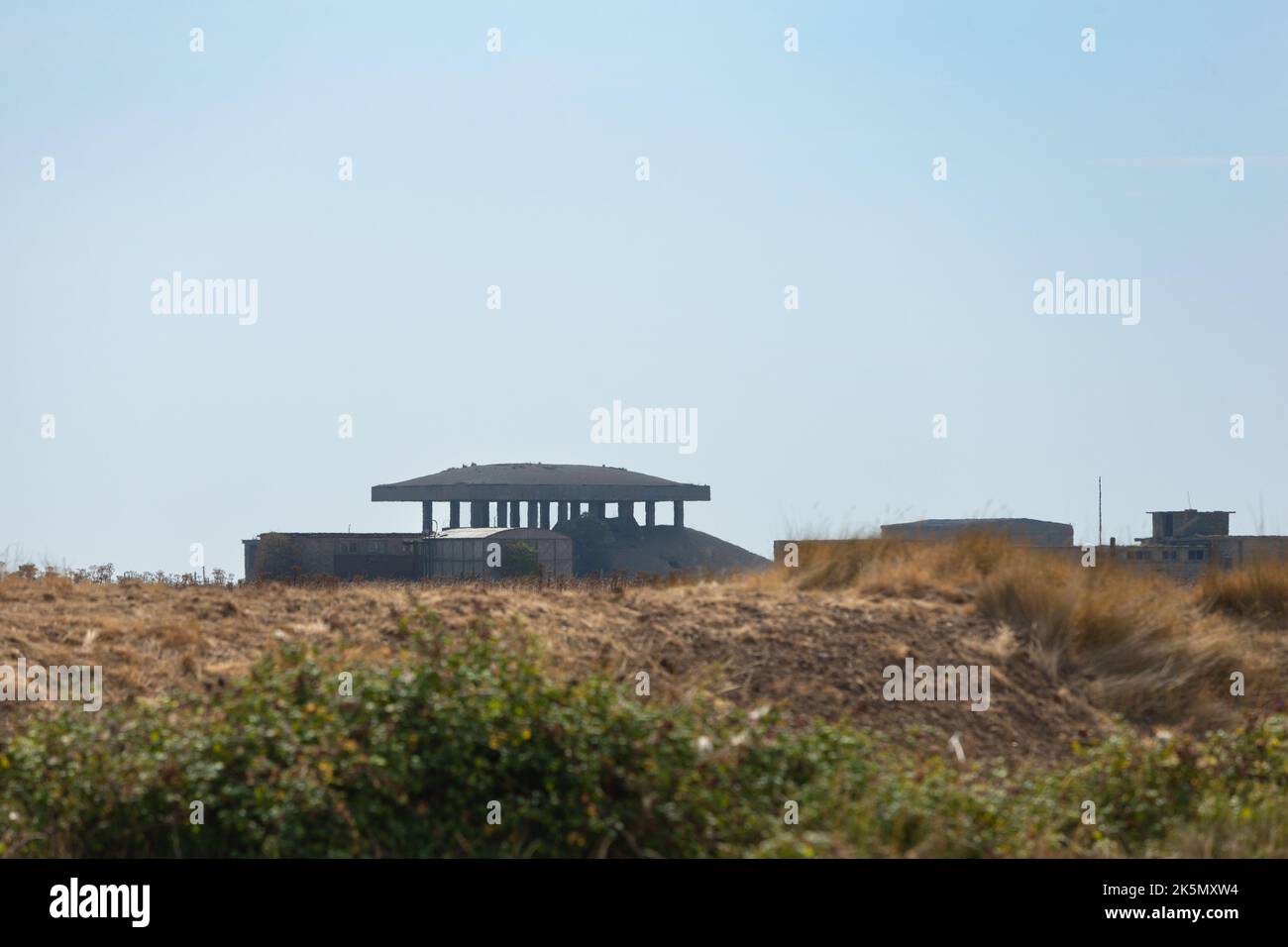 Landscape with atomic weapons research laboratory building with 'pagoda' blast roof in the distance, Orford Ness, Suffolk, England Stock Photo