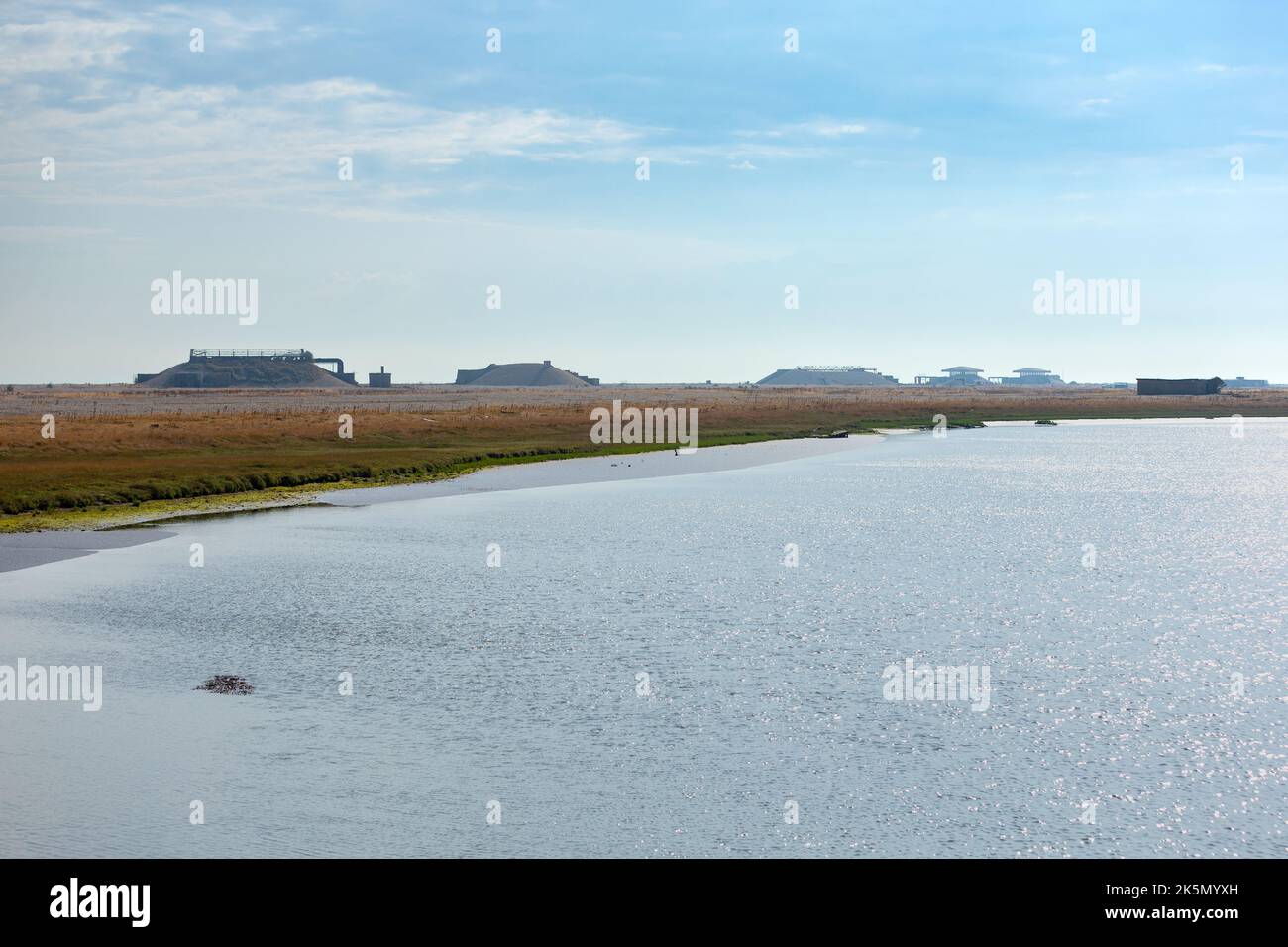 Watery landscape with former atomic weapons research testing laboratories in line on the horizon, Orford Ness, Suffolk Stock Photo