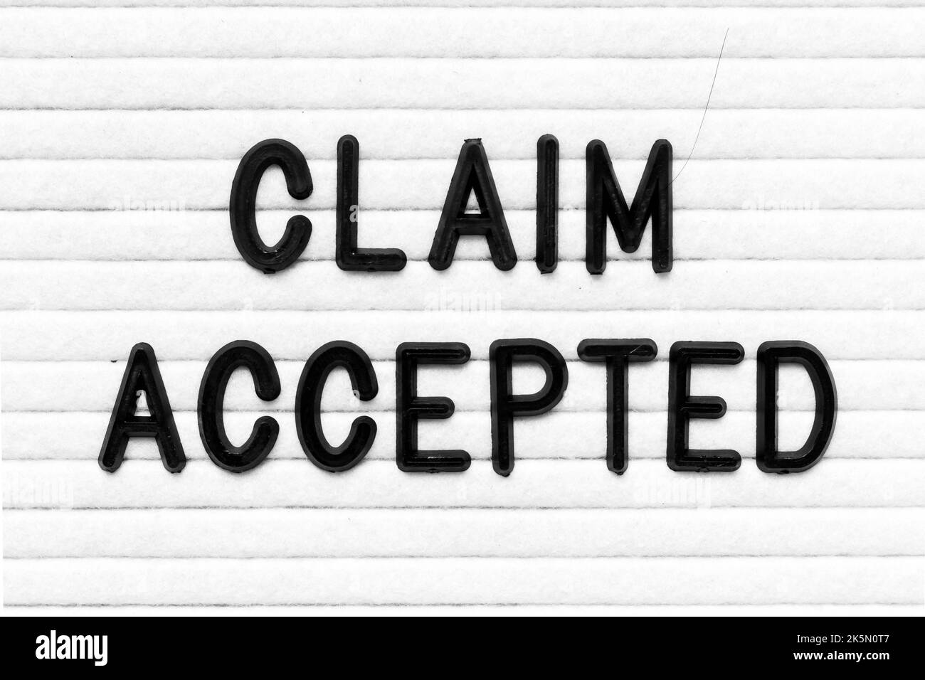 Black color letter in word claim accepted on white felt board ...