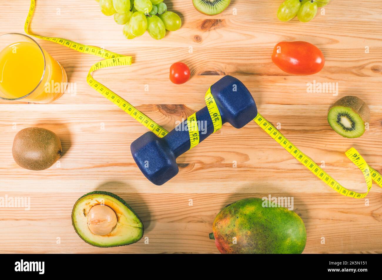 Fitness with dumbbell and genuine food with fresh fruit Stock Photo
