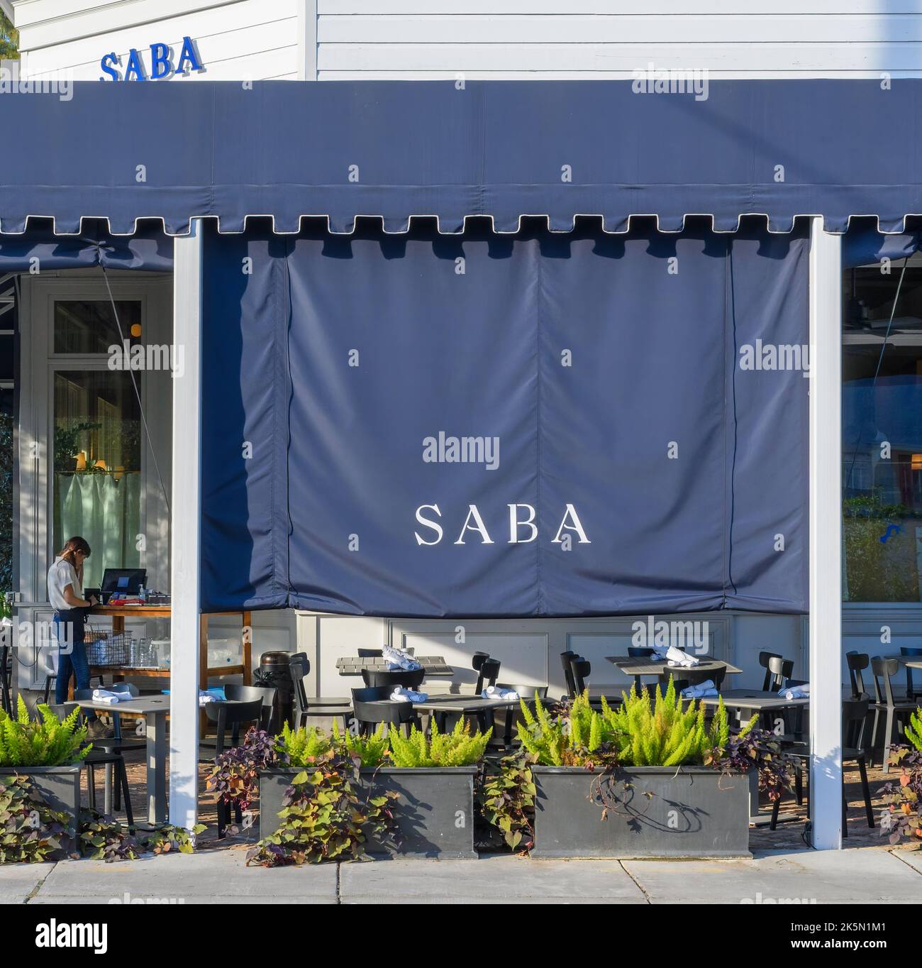 NEW ORLEANS, LA, USA - OCTOBER 6, 2022: Shaded outdoor dining area for Saba Restaurant on Magazine Street in Uptown New Orleans Stock Photo