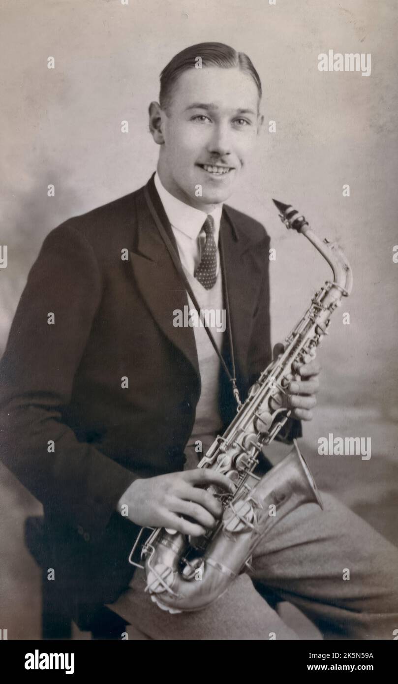 A portrait of a young man with his Alto Saxophone by the Los Angeles Portrait Studios, 75 Princes Street, Edinburgh, Scotland, UK Stock Photo