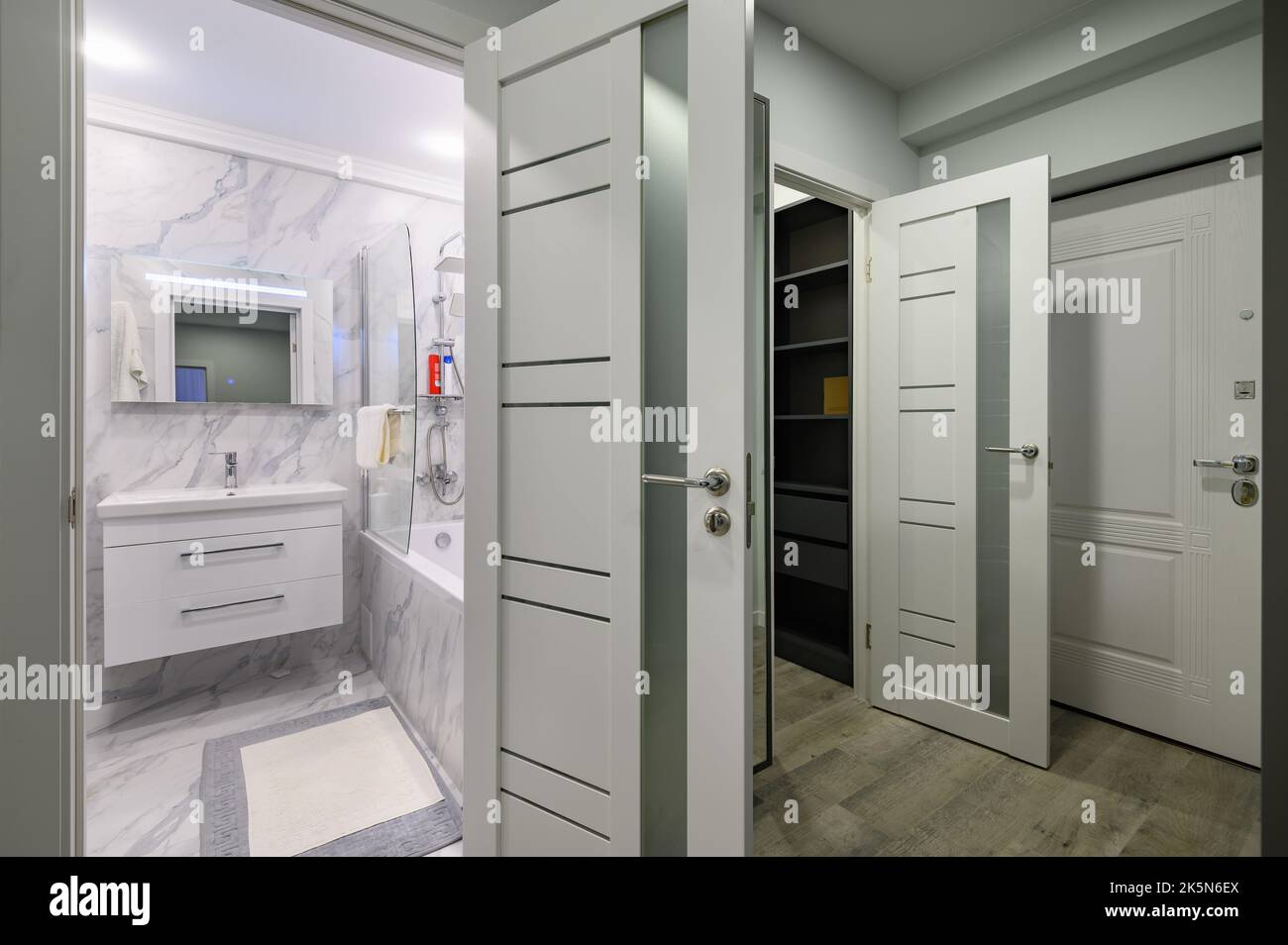 Entrance hall with doors to bathroom and wardrobe opened Stock Photo