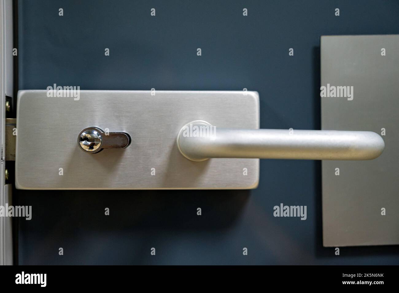 Close up modern white door with metal handle and lock Stock Photo - Alamy