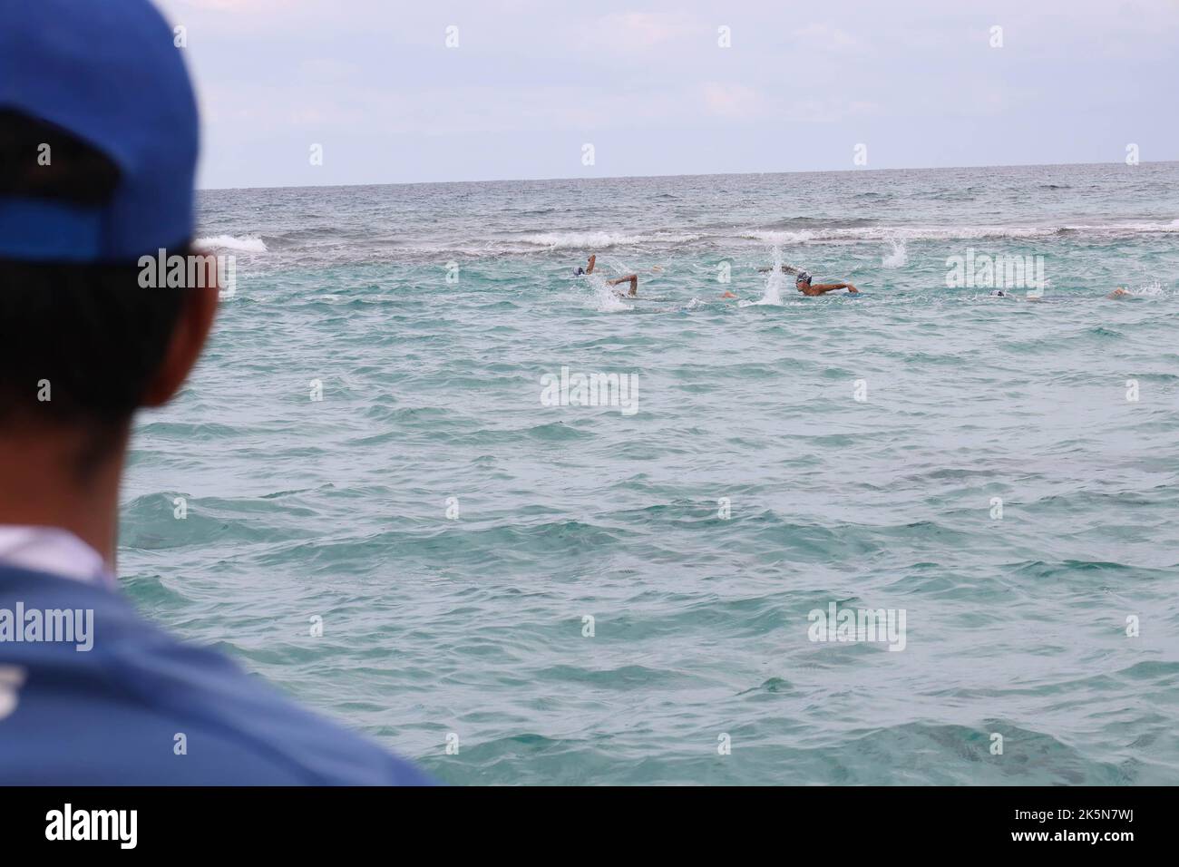 A marine lifeguard looks at the swimmers during the Libya Swimming
