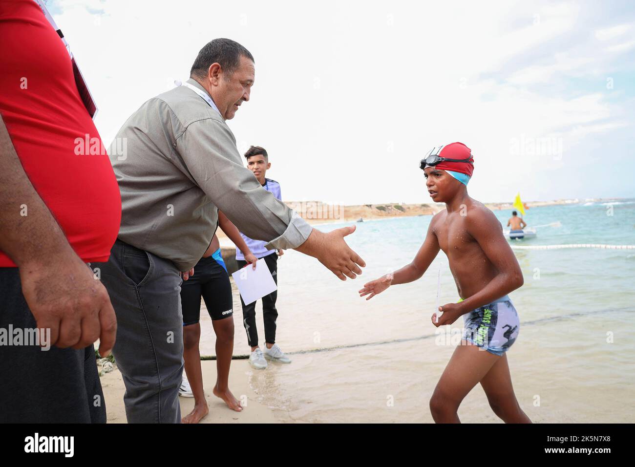 Morad Madi, one of the coaches congratulates a contestant during the Libya Swimming Competition in Misrata. The event had 75 swimmers and the competition included female participation for the first time in the history of Libya. Stock Photo