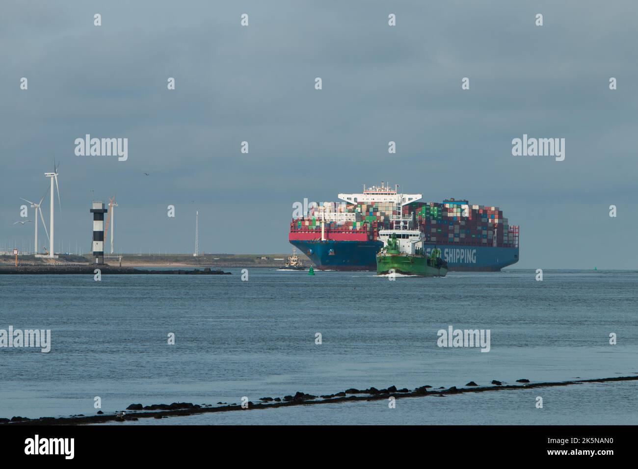 Cosco Shipping container ship moving up waterway towards port. Viewed