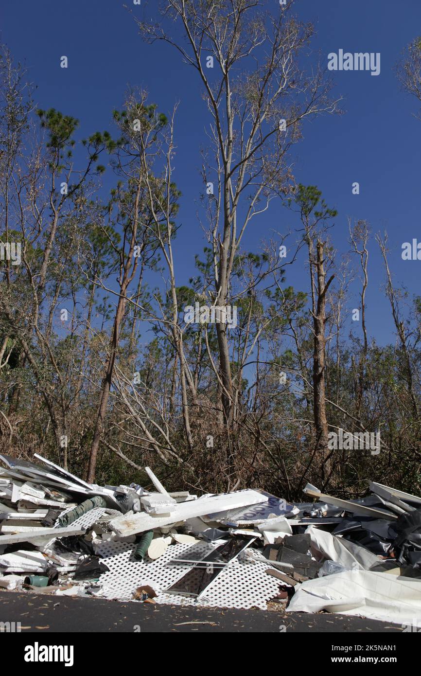 Debris from homes destroyed by Hurricane Ian lays along side of road