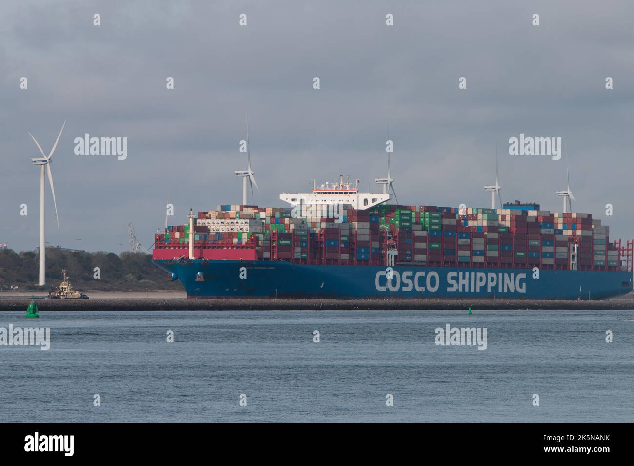Cosco Shipping container ship moving up waterway towards port. Viewed