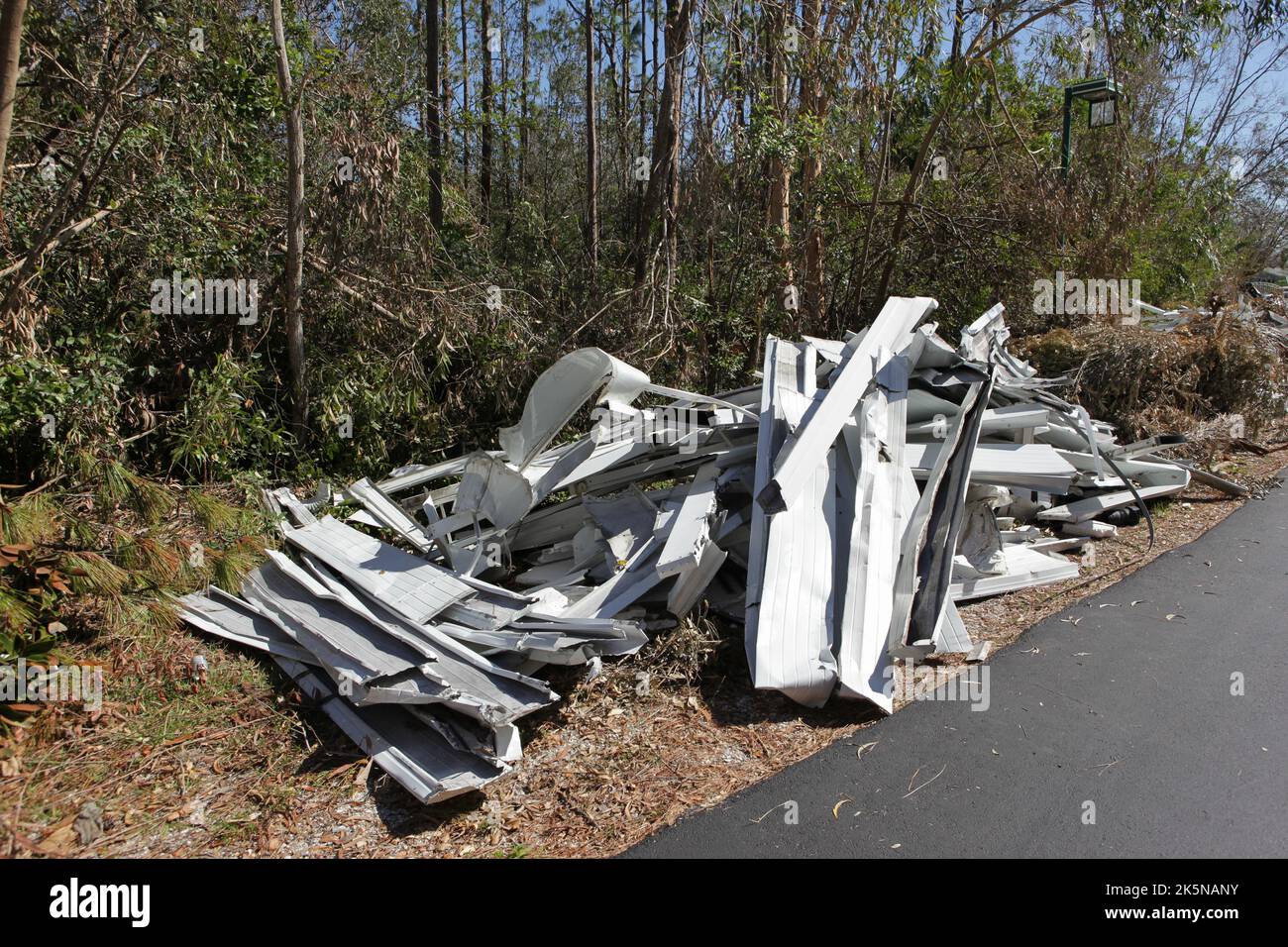 Debris from homes destroyed by Hurricane Ian lays along side of road awaiting pick up in North Fort Myers, Florida, Oct 8, 2022, © Katharine Andriotis Stock Photo