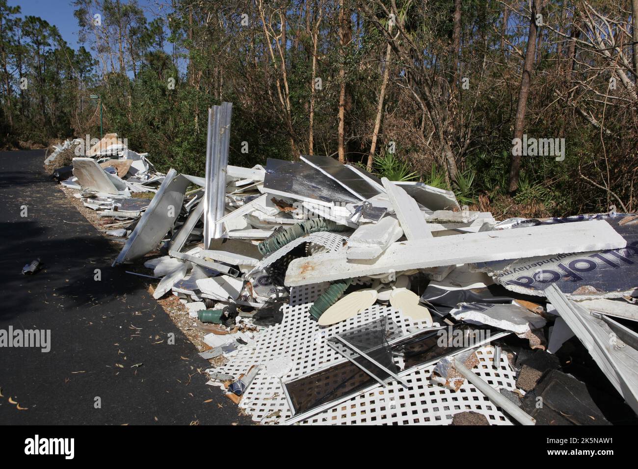 Debris from homes destroyed by Hurricane Ian lays along side of road awaiting pick up in North Fort Myers, Florida, Oct 8, 2022, © Katharine Andriotis Stock Photo