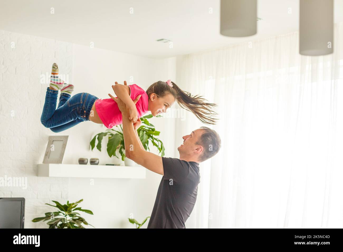 Cute young daughter on a piggy back ride with her dad Stock Photo - Alamy