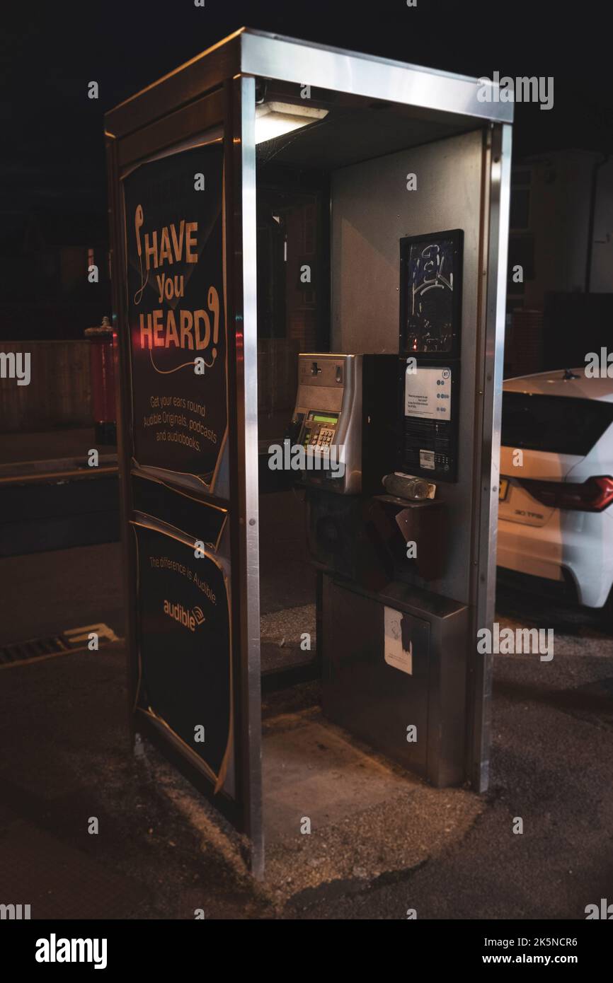 A phonebox is seen in a British city with the receiver off the hook ...