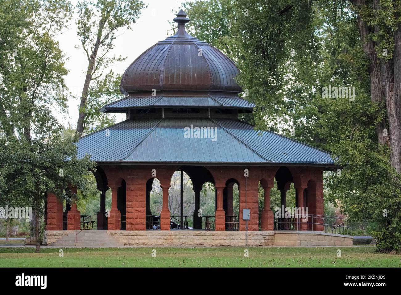 An antiquated stone gazebo in a park. Stock Photo