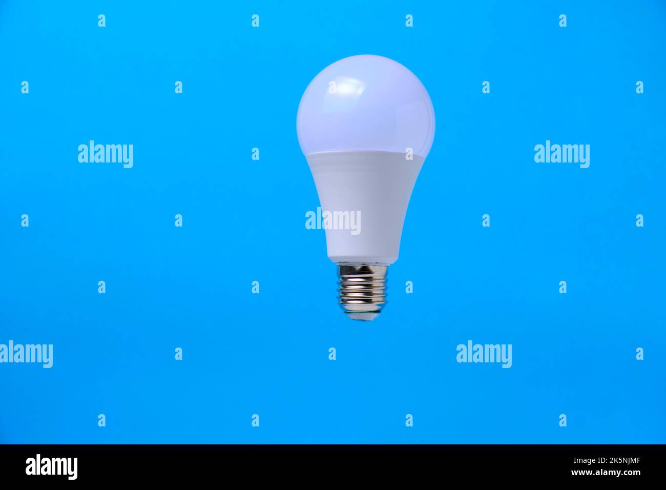 LED eco light bulb on blue background Stock Photo