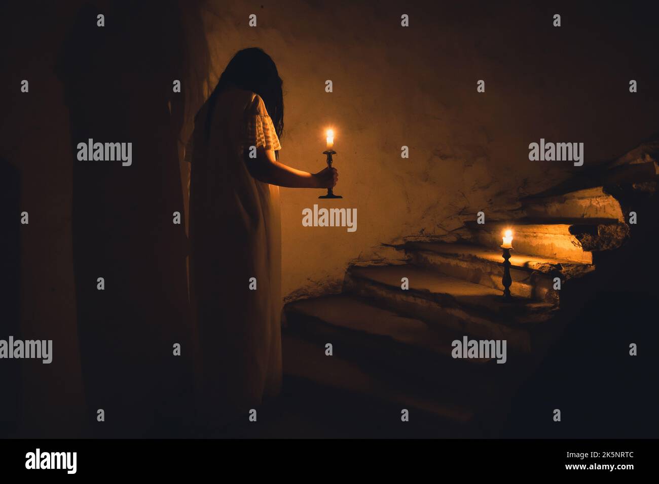 Ghost in abandoned, haunted house. Horror scene of scary spirit of a woman, halloween concept. Stock Photo