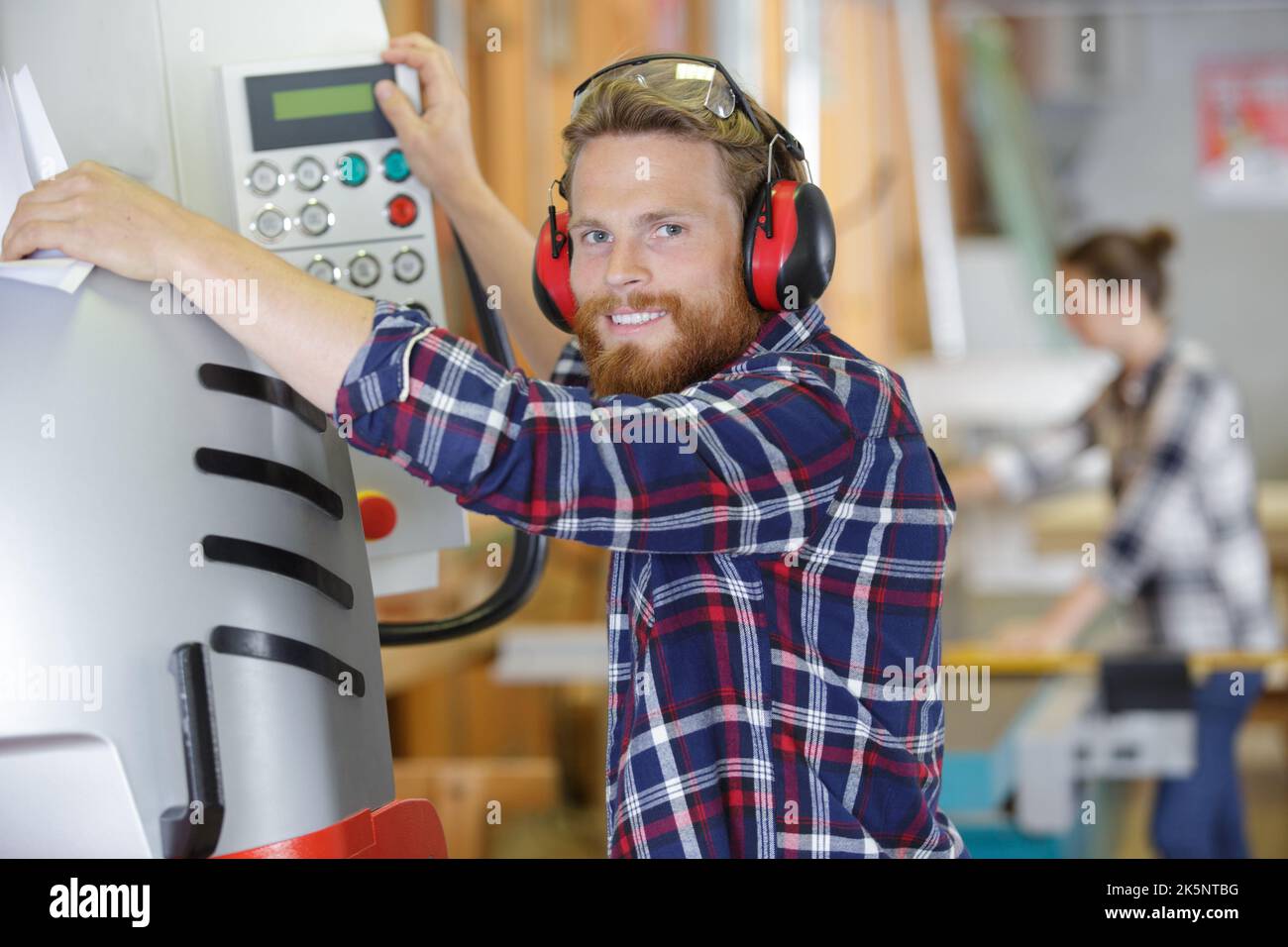 industrial worker operates a machine Stock Photo