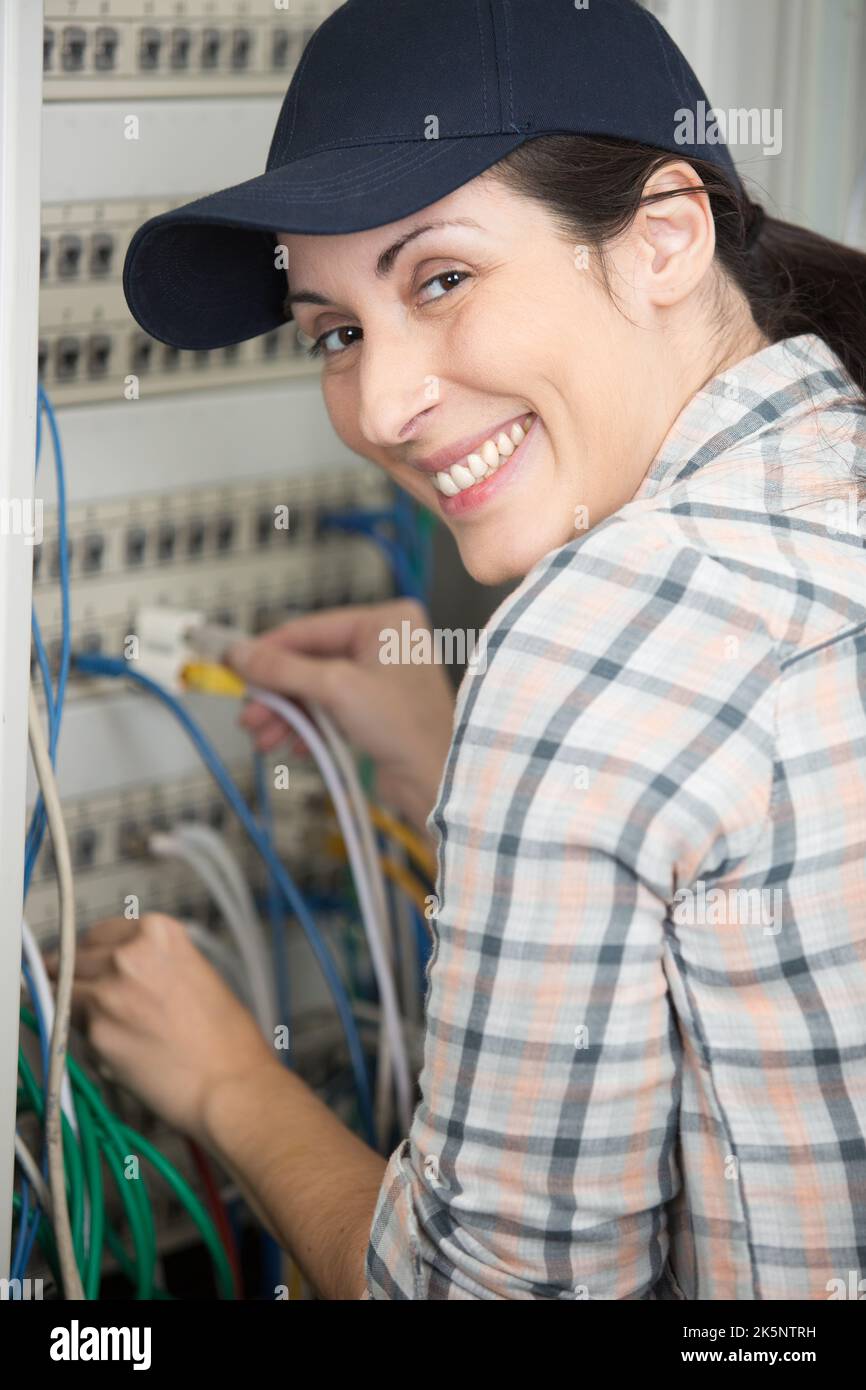 technician connecting wires on server in data center Stock Photo