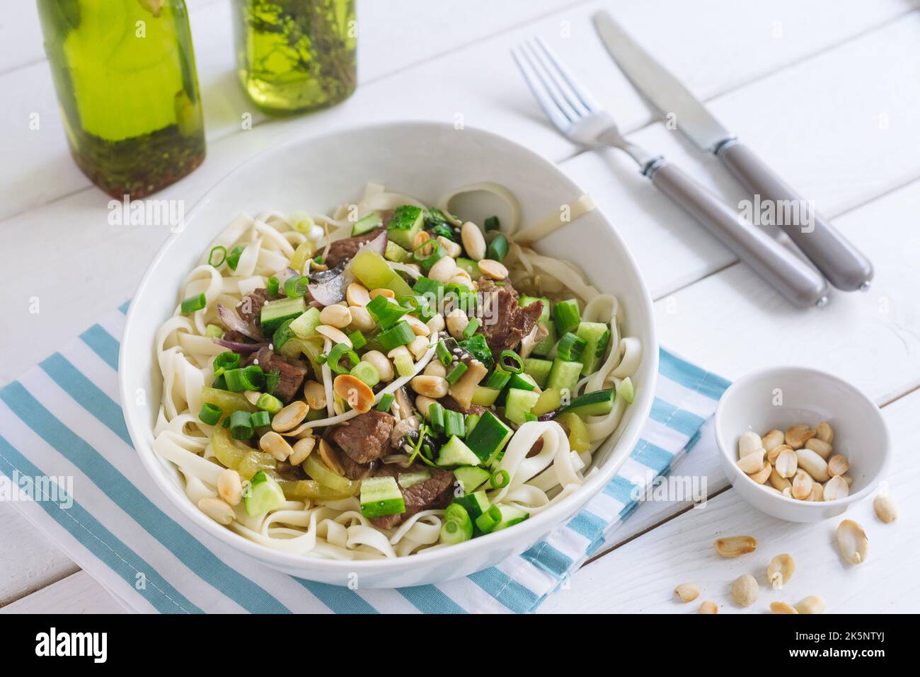 Udon noodles with chunks of beef, peanuts, sprouted sprouted beans and