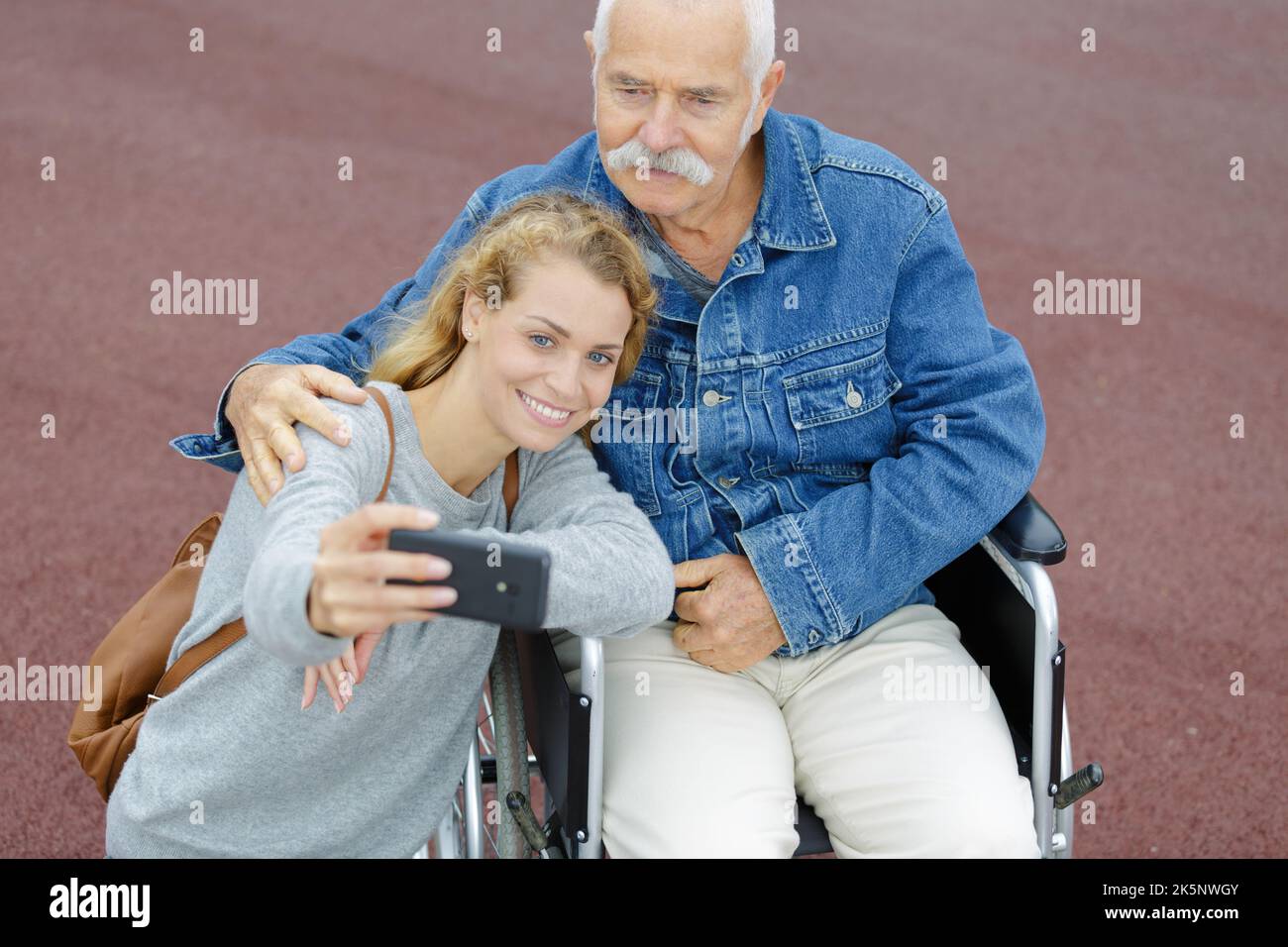 elderly man in wheelchair and young woman taking selfie Stock Photo - Alamy
