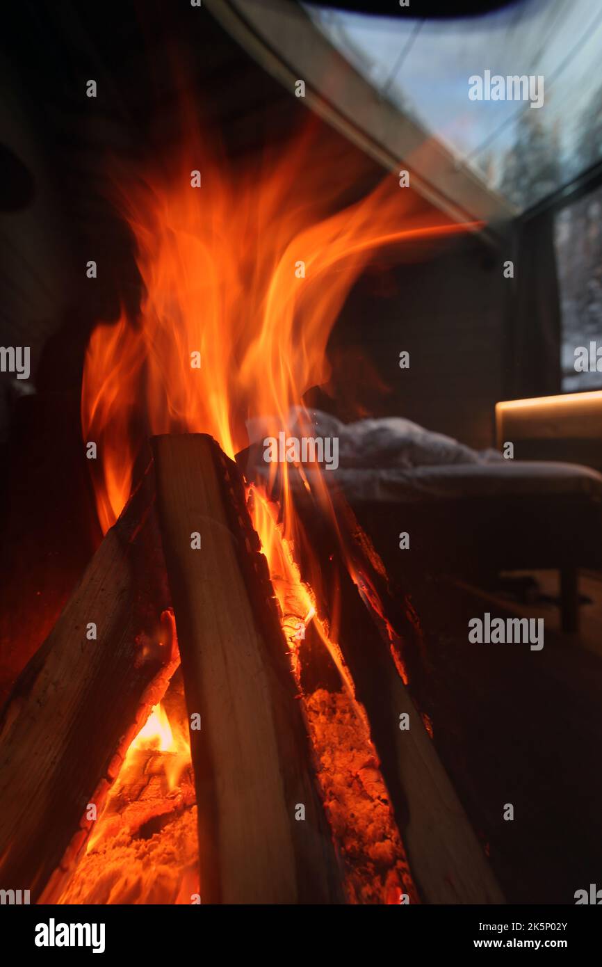 Spa Hotel Järvisydän, Rantasalmi, Finland, January, 2021: Fireplace with a big bonfire in a Finnish hotel during wintertime. Cozy atmosphere and warm Stock Photo