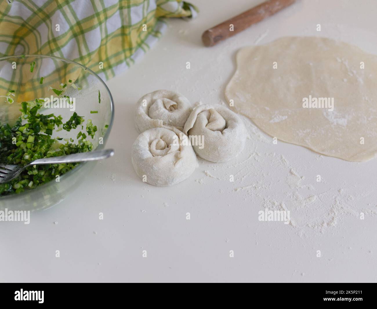 Chinese food in making. Scallion pancake, a traditional pastry people make at home. Stock Photo