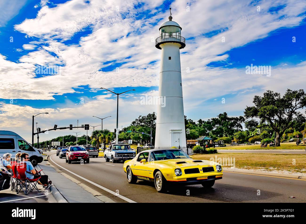 A vintage Pontiac Firebird Formula passes the Biloxi lighthouse during