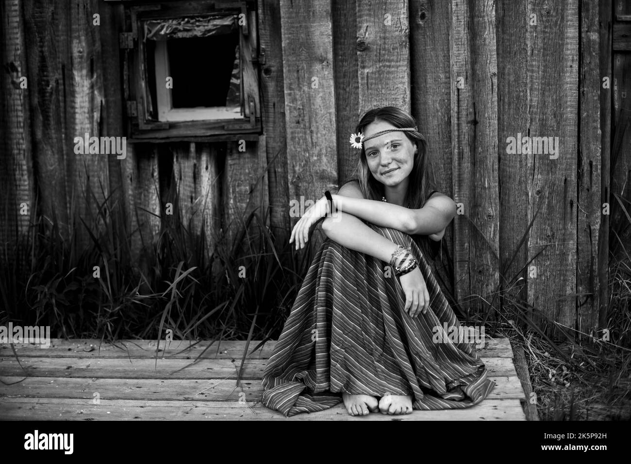A young hippy girl outdoors in the village. Black and white photo. Stock Photo