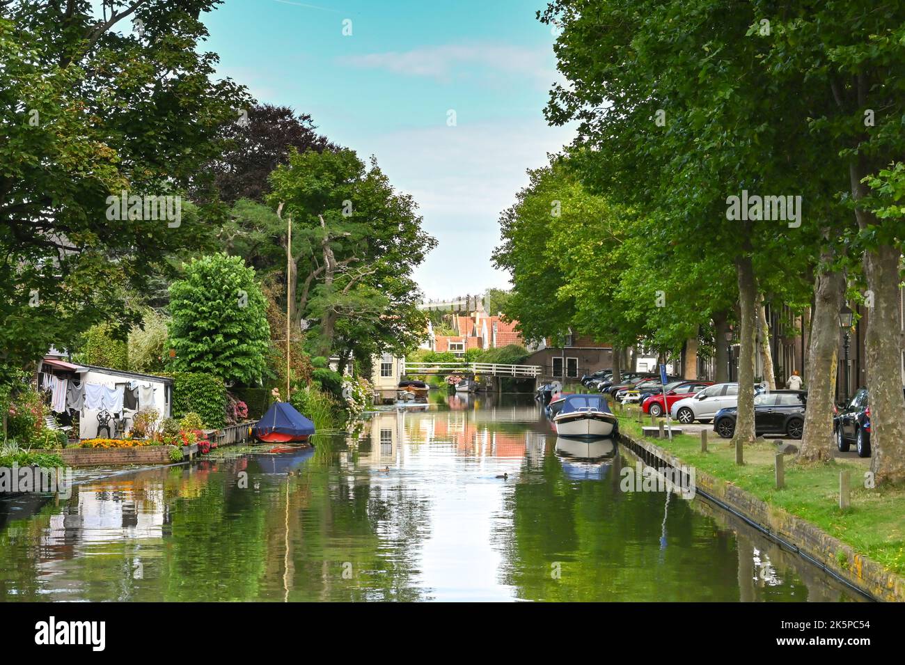 Zaandam, Netherlands - August 2022: Boats on a treelined canal in the Dutch town of Edam, which is famous for its cheese. Stock Photo