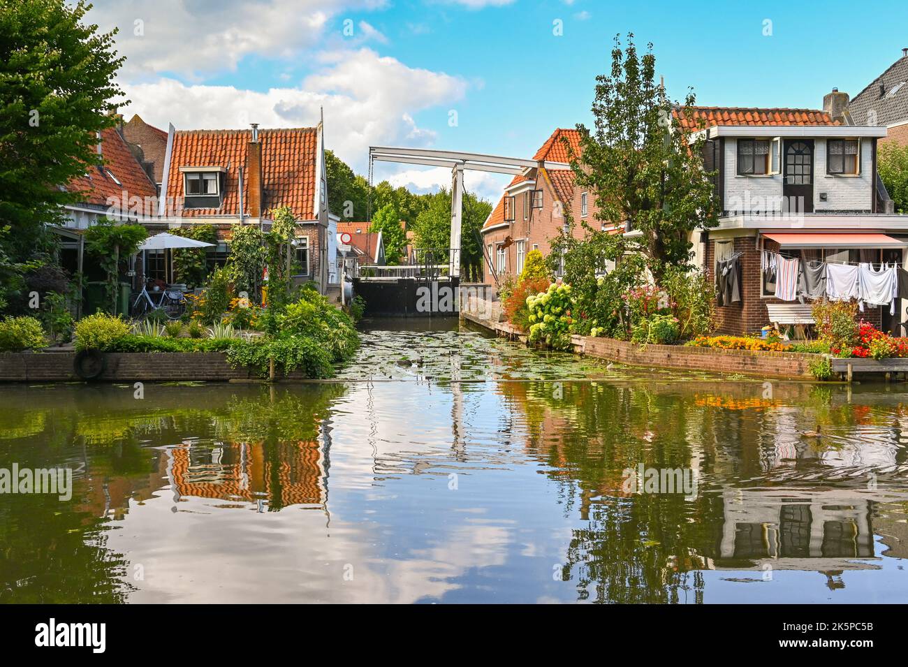 Zaandam, Netherlands - August 2022: Houses alongside one of the canals in the centre of the Dutch town of Edam, which is famous for its cheese. Stock Photo