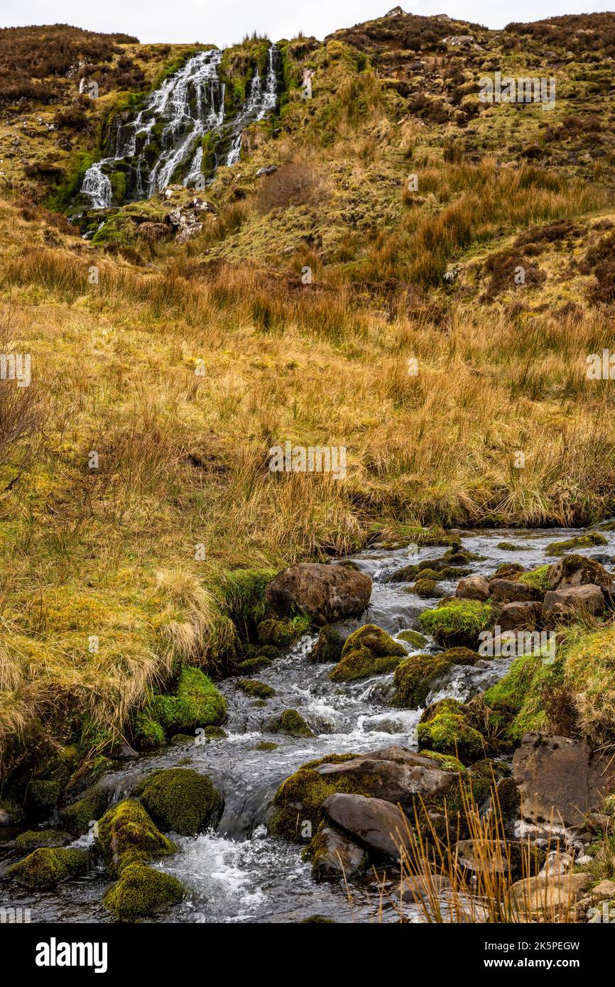 A beautiful waterfall flowing down the rocks covered in moss Stock ...