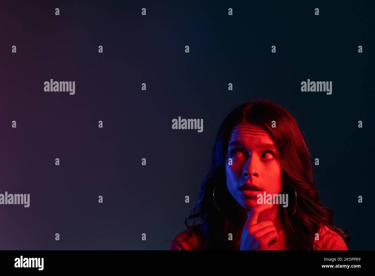 pensive woman neon light people red advertising Stock Photo