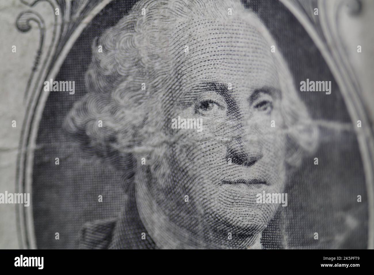 Macro view of George Washington on worn out dirty US one dollar bill. Stock Photo
