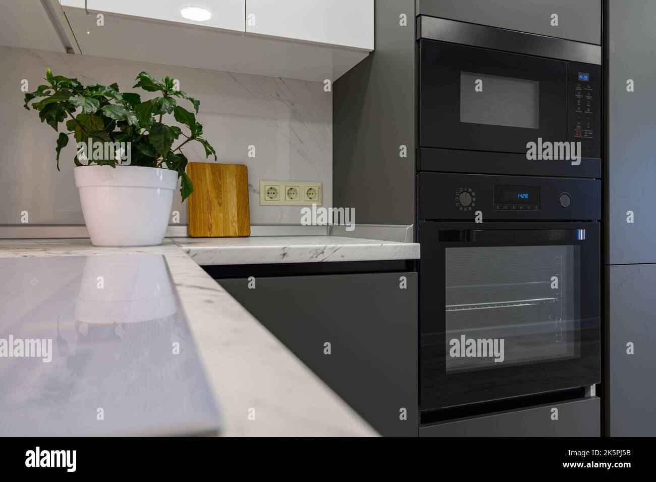 Marble worktop of modern white and dark grey kitchen Stock Photo Alamy