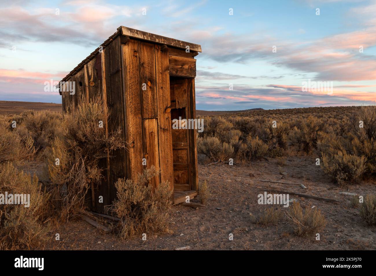An outhouse sits in the sagebrush at Bitner Ranch in northwester Nevada. Stock Photo