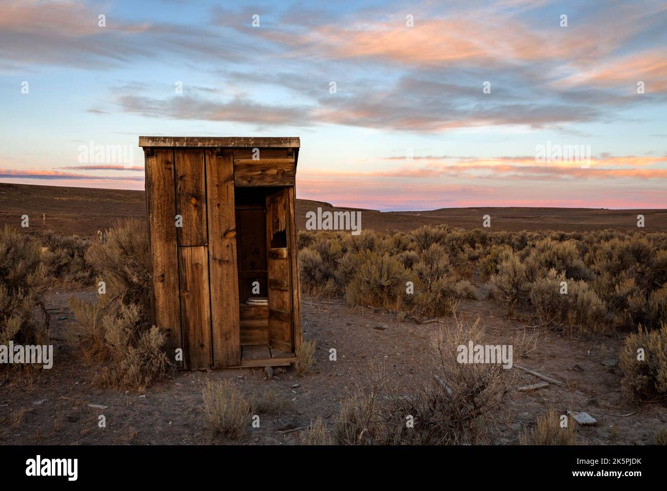 An outhouse sits in the sagebrush at Bitner Ranch in north western Nevada. Stock Photo