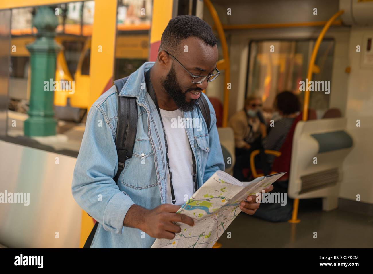 Young adult man with map at terminal train station Stock Photo