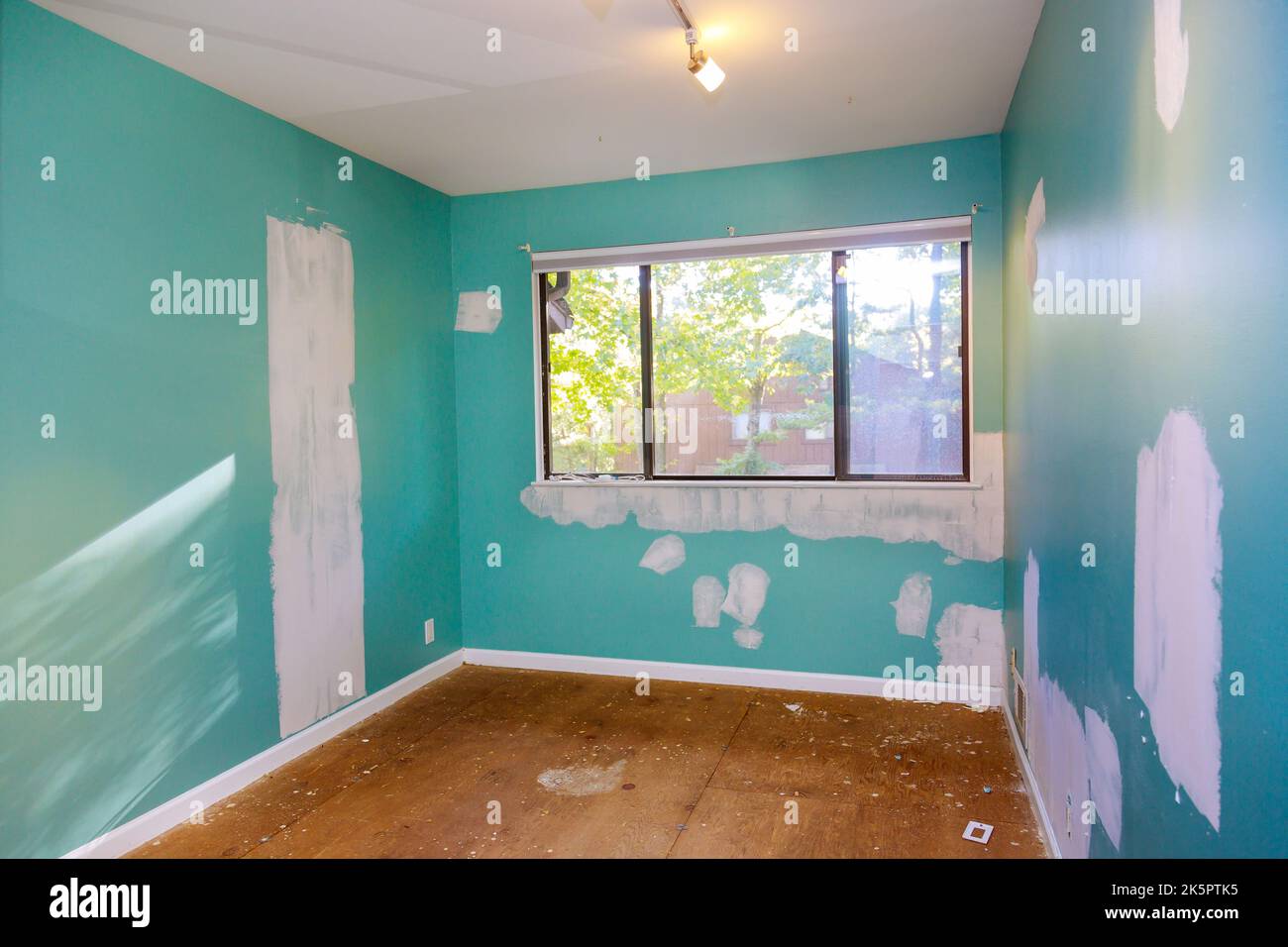 Damaged cracks wall drywall ceiling with repair using a spatula for