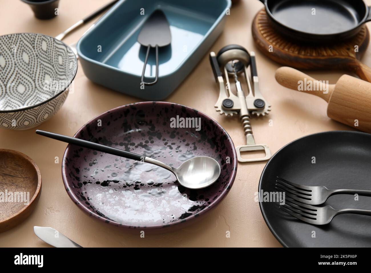 Many different tableware and kitchenware on color background Stock Photo