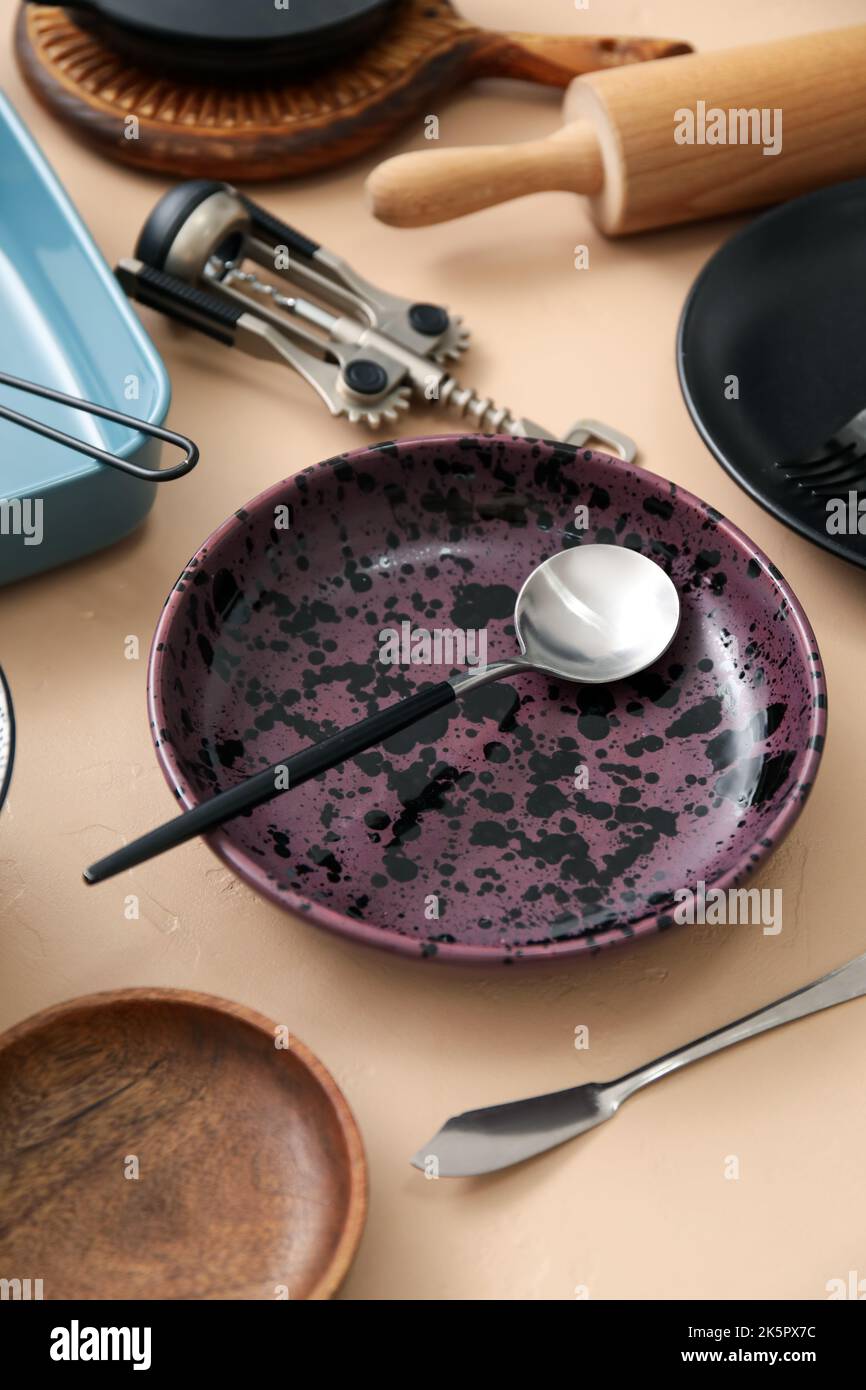 Many different tableware and kitchenware on color background Stock Photo