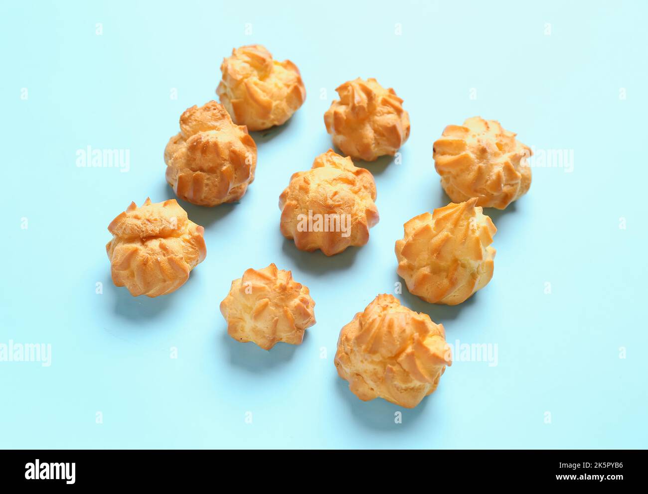 Composition with delicious eclairs on color background Stock Photo