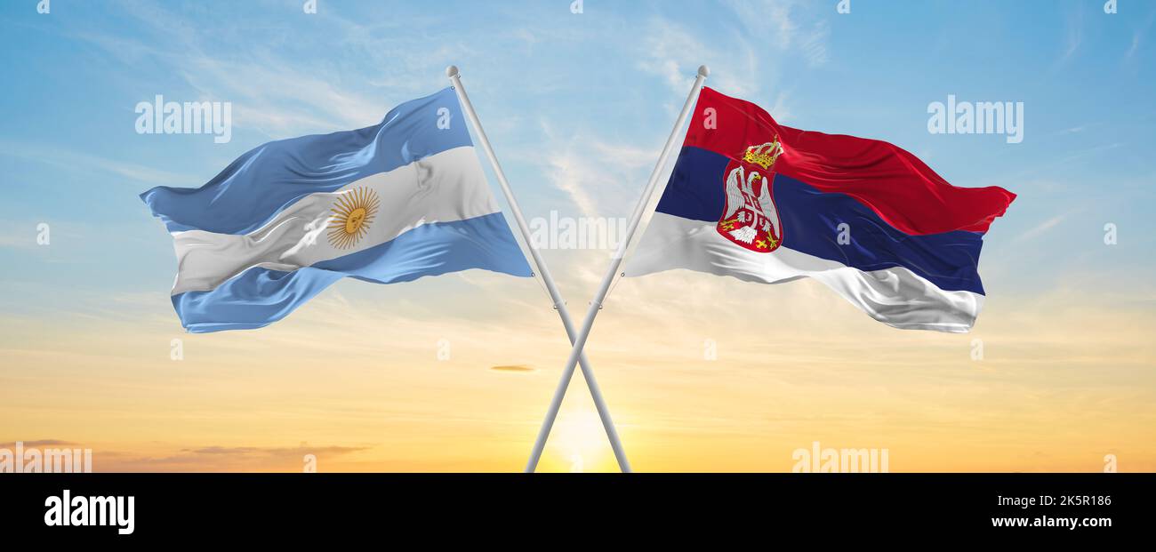 crossed national flags of Argentine and Serbia flag waving in wind at ...