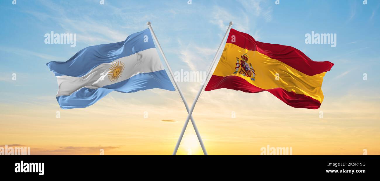 crossed national flags of Argentine and Spain flag waving in wind at ...
